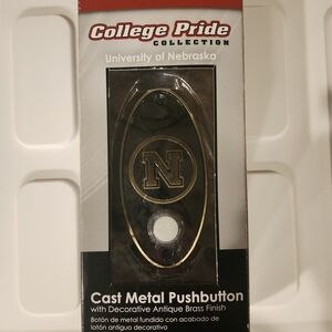 University Of Nebraska Cast Metal Pushbutton with Antique Brass Finish